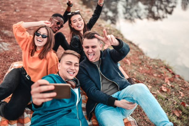 istock Selfie By Smiling Friends In The Park 1304033366