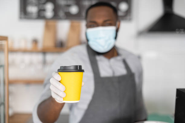 istock An African waiter in a medical mask 1304034151