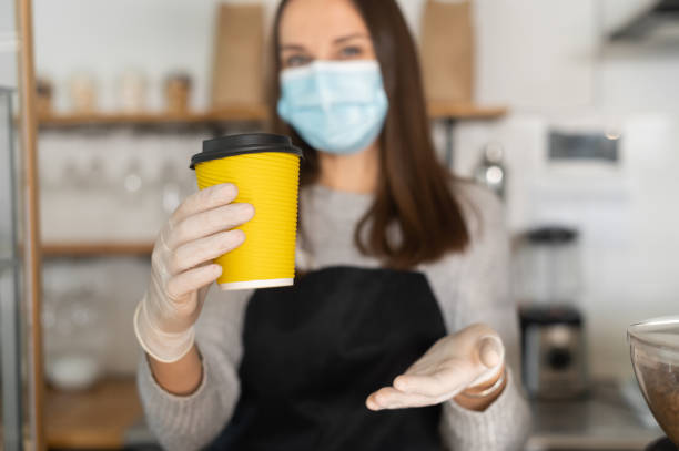 istock A waitress in a medical mask 1304034504