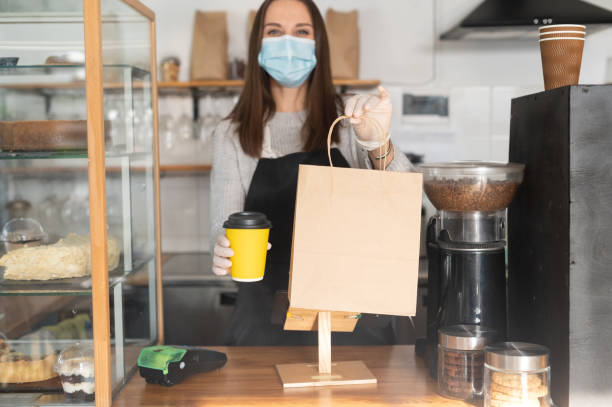 istock A waitress in a medical mask 1304034510