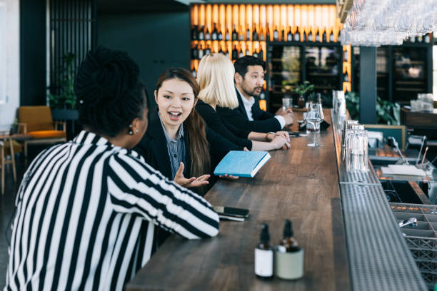 istock Women having a discussion behind a bar counter 1304035374