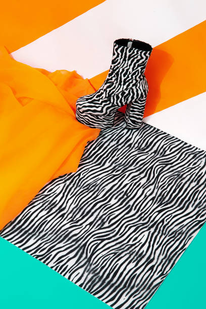 istock Stylish platform boots on bright striped yellow background. Tropical exotic creative minimal concept. Yellow and zebra print mixed. Still life fashion scene 1304039605