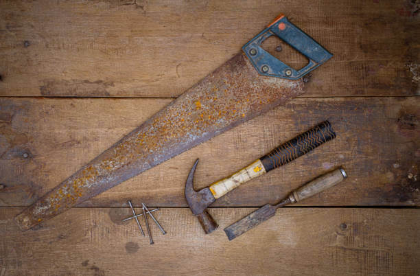 Hammer saw and chisel Collection of woodworking old handtools Hammer saw and chisel Collection of woodworking old handtools on a rough workbench wooden work tool nail wood construction stock pictures, royalty-free photos & images