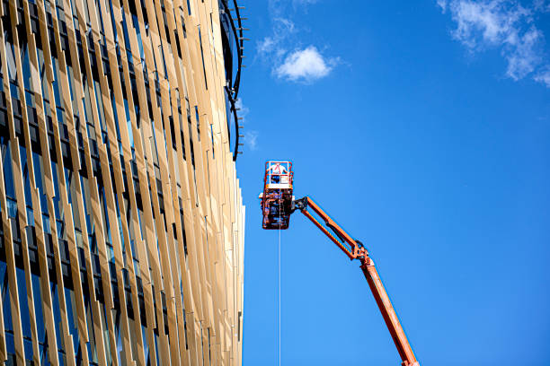 istock Window washer at work while washing windows on an office building stock photo 1304040831