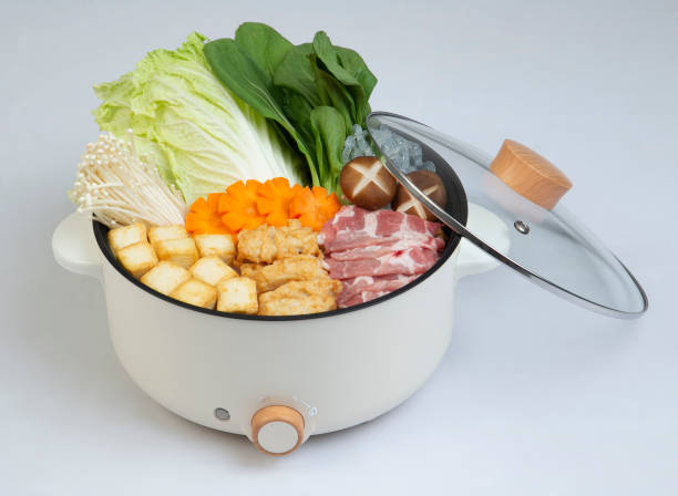 istock Electric pot and cover with vegetable and meat isolated 1304043783