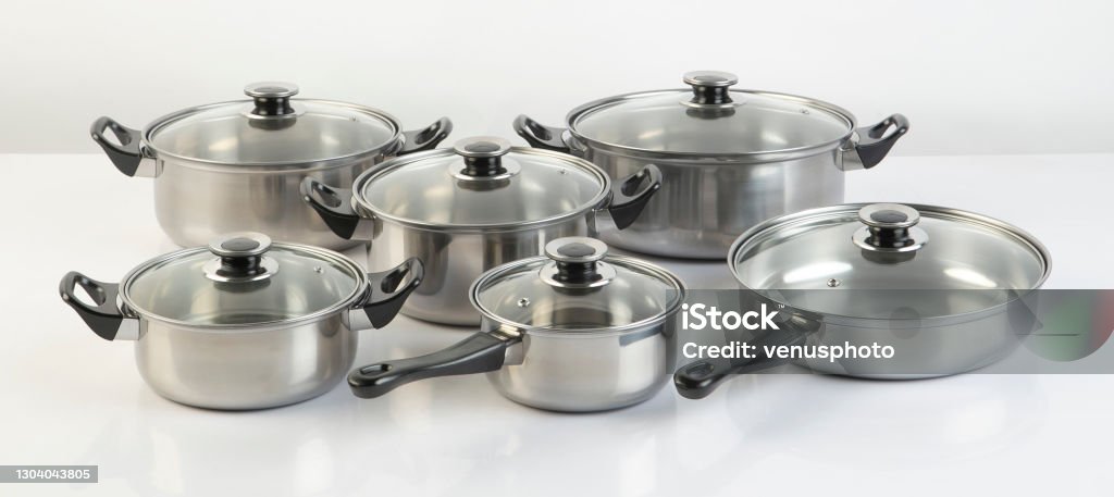 Set of stainless pots with lids isolated on white Set of stainless pots with lids isolated on white background Cooking Pan Stock Photo