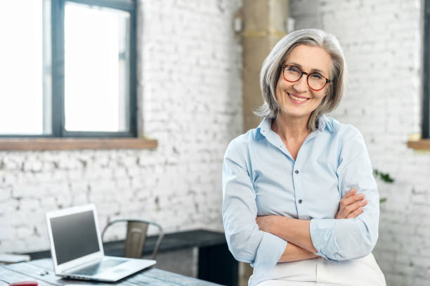 istock Positive businesswoman standing with arms folded 1304046399