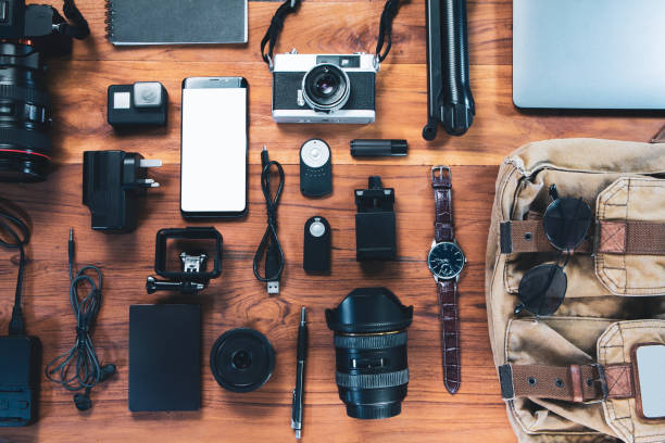 istock Top view digital camera,film camera, charger, camera, lens, video camera, USB, personal laptop, book, glasses, remote control, electronics camera accessory photography concept on wooden background 1304046832