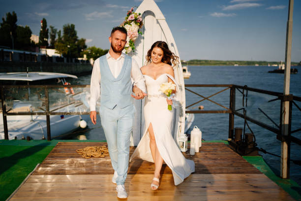 istock wedding ceremony by water on dock. bride and groom. 1304046934