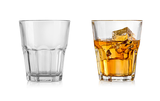 Empty and full whiskey glass isolated on white background with clipping path