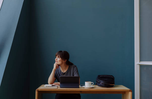 istock Women in Business: a Smiling Young Businesswoman Using a Digital Tablet at her Office 1304049602