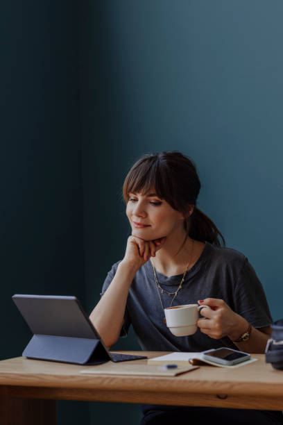 istock Women in Business: a Smiling Young Businesswoman Using a Digital Tablet at her Office 1304049608