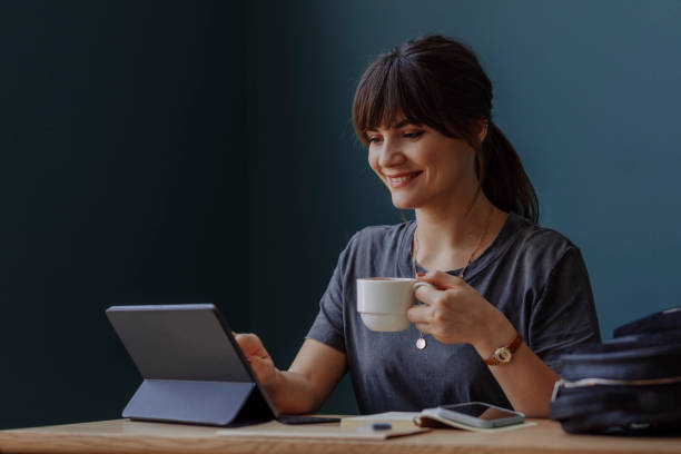 istock Women in Business: a Smiling Young Businesswoman Using a Digital Tablet at her Office 1304049609