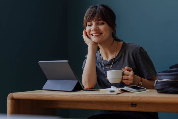 istock Women in Business: a Smiling Young Businesswoman Using a Digital Tablet at her Office 1304049615