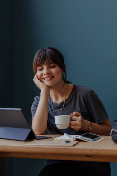 istock Women in Business: a Smiling Young Businesswoman Using a Digital Tablet at her Office 1304049620