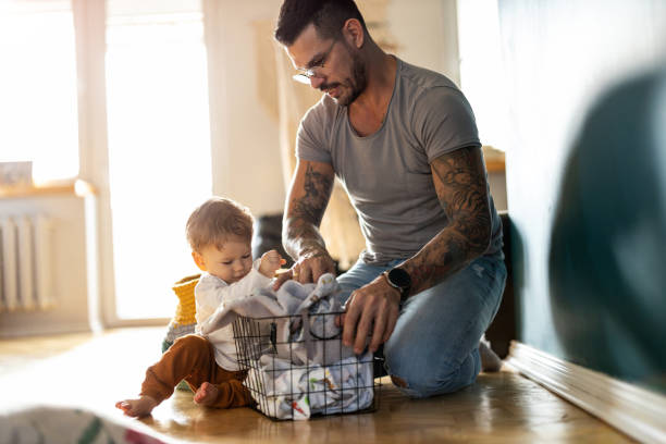 father and son doing laundry together - tattoo father family son imagens e fotografias de stock