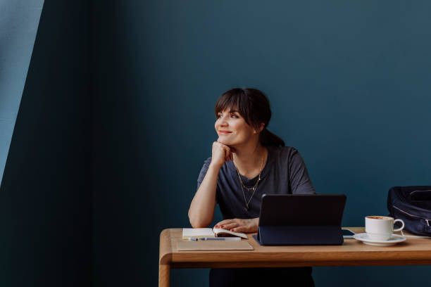 istock Women in Business: a Smiling Young Businesswoman Using a Digital Tablet at her Office 1304049632