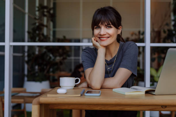istock Women in Business: a Smiling Young Businesswoman Using a Laptop at her Office 1304049646