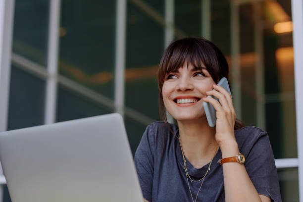 istock Women in Business: a Smiling Young Businesswoman Using a Laptop at her Office 1304049664
