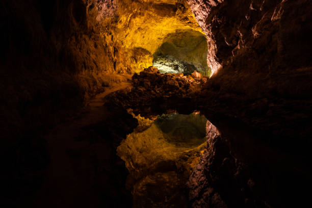istock Optical reflection effect on cave lava tube illuminated in Canary Islands 1304051939