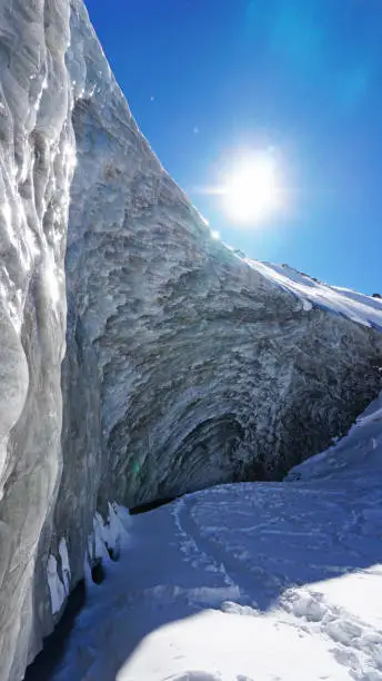 Photo of High ice wall in mountains. Bogdanovich Glacier