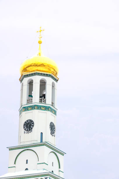 Church bell tower white Easter sky background with copy space. Religion holiday concept.