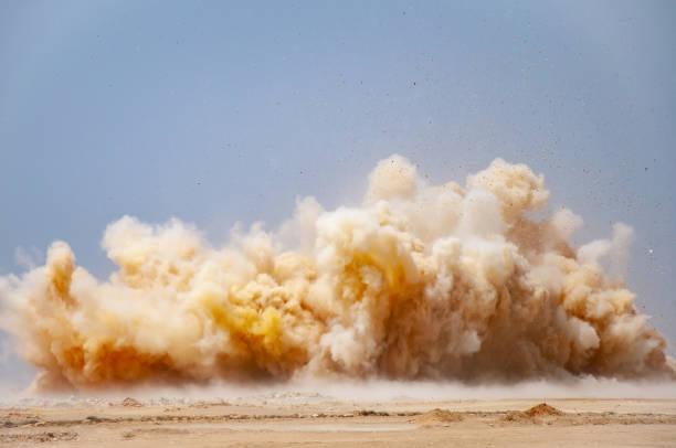 Dust storm after detonator blast on the mining site Dust clouds and flying rock particles during detonator blast in the desert dust storm stock pictures, royalty-free photos & images