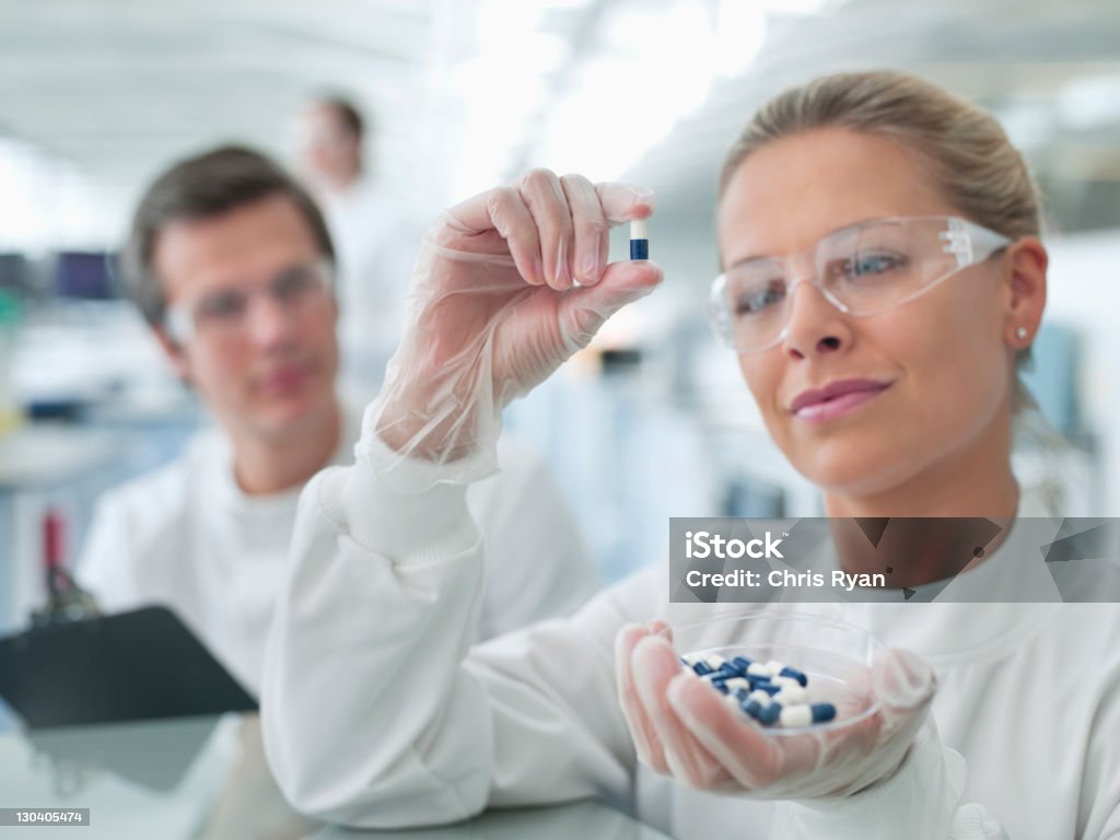 Scientists examining pills in lab  Medicine Stock Photo