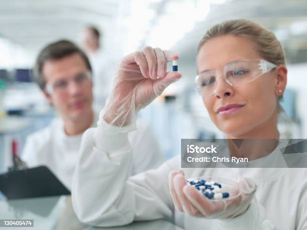 Scientists Examining Pills In Lab Stock Photo - Download Image Now - Medicine, Pill, Capsule - Medicine