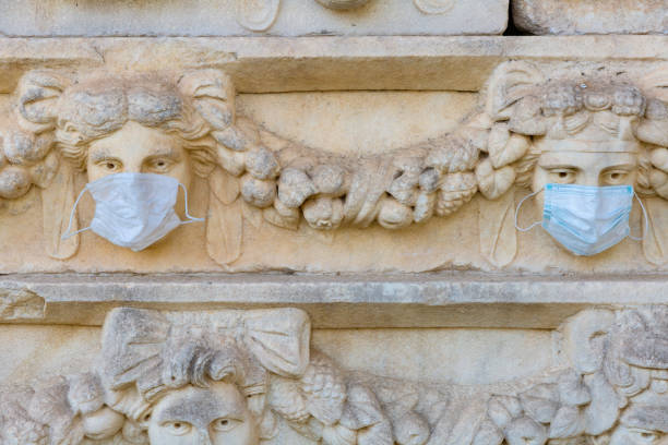 relief sculptures with wearing medical masks in ancient city of aphrodisias. turkey - mugla province imagens e fotografias de stock