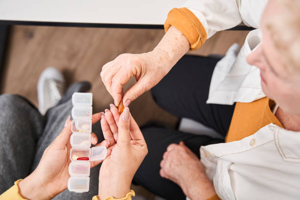 istock Medical worker explaining about pills to her patient 1304055947