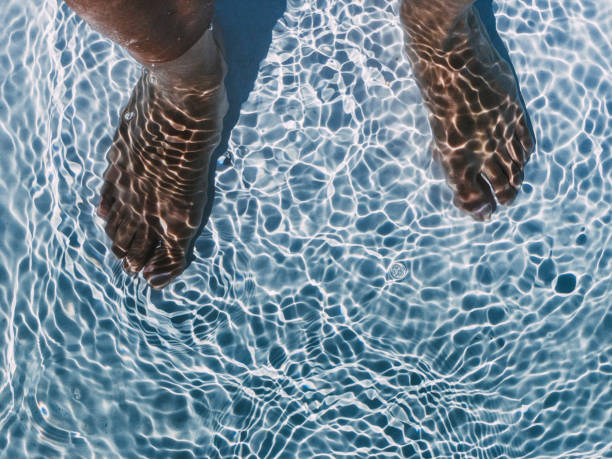 istock Crop man in clear swimming pool 1304057604