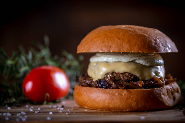 istock Craft beef burger with cheese and sauce on wooden background 1304061917