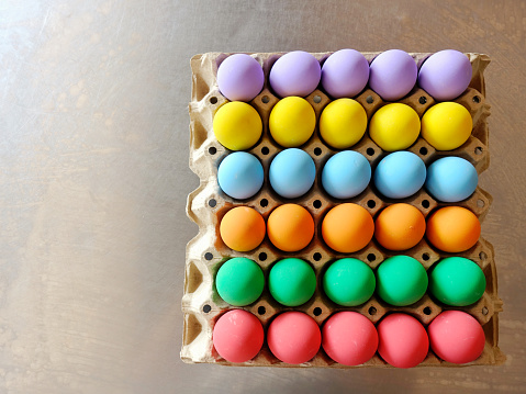 Top view colorful Eggs in panel on the table.