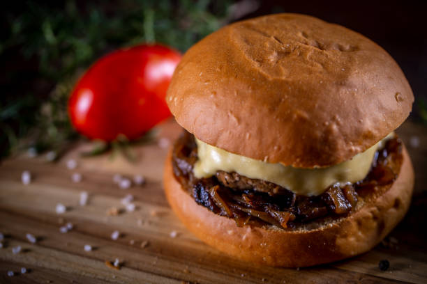 istock Craft beef burger with cheese and sauce on wooden background 1304062040