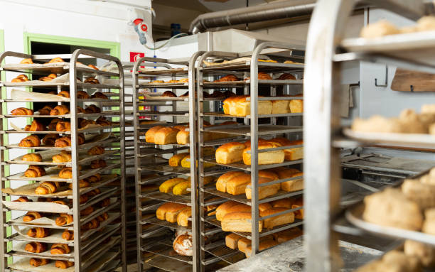 istock Freshly baked bread on trolley in bakery 1304063351