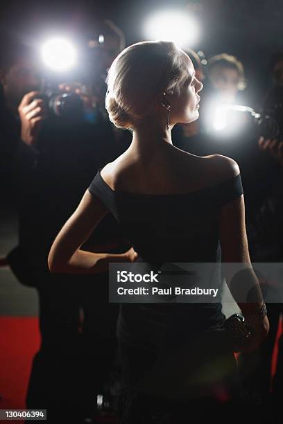 Celebrity Posing For Paparazzi On Red Carpet Stock Photo - Download Image Now - Red Carpet Event, Women, Paparazzi Photographer