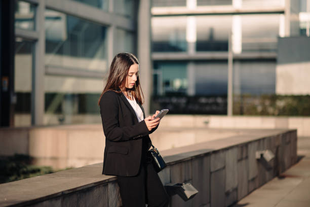 istock Young businesswoman using her smart phone 1304064483