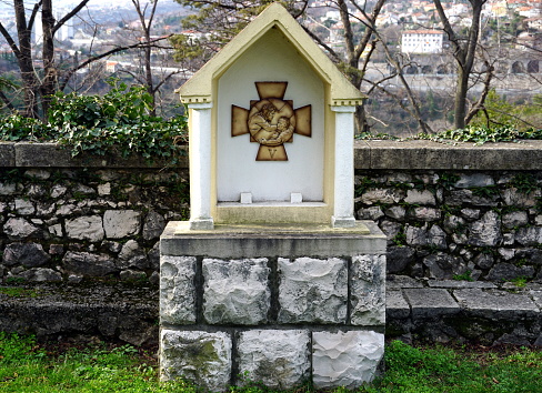 Stone stations of the Cross or Way of the Cross, 5th station, Simon of Cyrene is made to bear the cross in the Virgin Mary sanctuary in town of Rijeka in Croatia