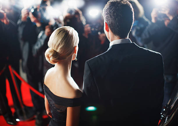 Celebrities posing for paparazzi on red carpet  red carpet event photos stock pictures, royalty-free photos & images