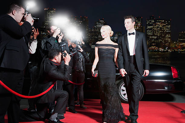 Celebrities posing for paparazzi on red carpet  evening gown photos stock pictures, royalty-free photos & images