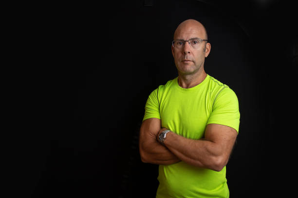 istock Muscular middle aged keep fit instructor posing on a black easy to extend background 1304065617