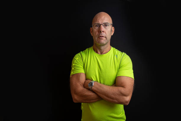istock Muscular middle aged keep fit instructor posing on a black easy to extend background 1304065630