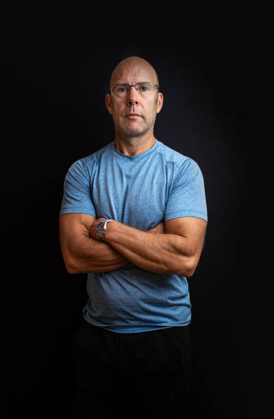 istock Muscular middle aged keep fit instructor posing on a black easy to extend background 1304065634