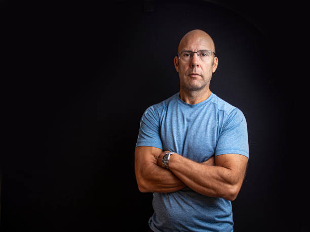 istock Muscular middle aged keep fit instructor posing on a black easy to extend background 1304065646