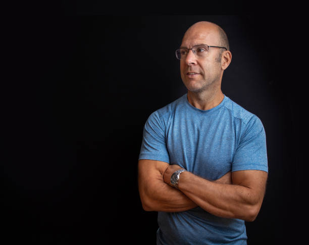 istock Muscular middle aged keep fit instructor posing on a black easy to extend background 1304065662