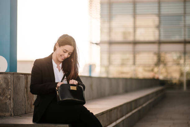 istock Young woman searching inside her purse 1304067037
