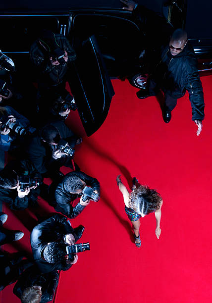 Celebrity walking past paparazzi on red carpet  red carpet event photos stock pictures, royalty-free photos & images