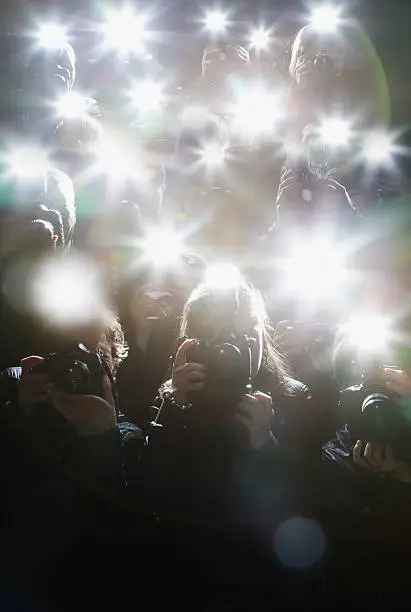 Photo of Paparazzi taking pictures with flash