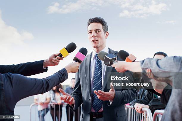Politician Talking Into Reporters Microphones Stock Photo - Download Image Now - Politician, Journalist, Press Conference
